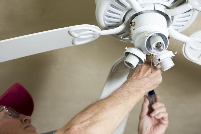 Handyman Working on a Ceiling Fan